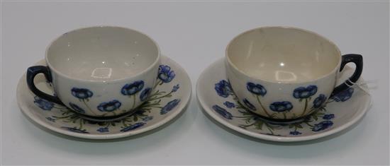 Two Macintyre Burslem Blue Poppy pattern white ground cups and saucers, early 20th century saucer 14cm, one cup and saucer restored